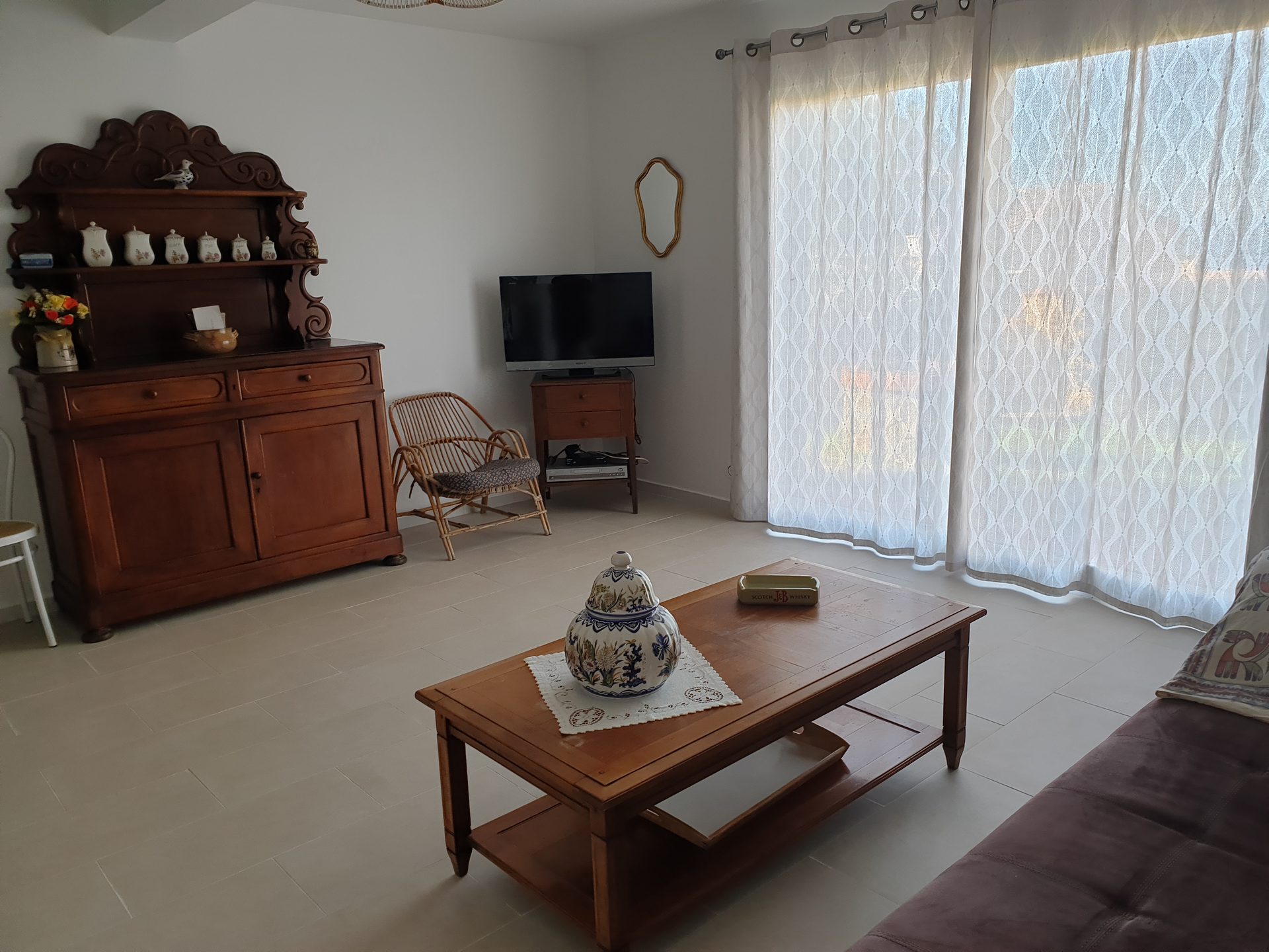 Living room of Bagatelle with wooden furniture and large picture window